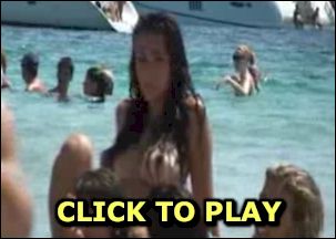 Topless brunette at the beach