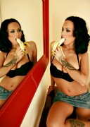 Busty Dominno sucking and licking a banana