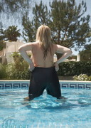 Busty blonde wet in a pool