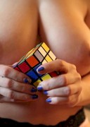 Topless babe with a Rubiks Cube