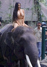 Kim Kardashian on top of an elephant