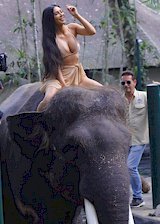 Kim Kardashian on top of an elephant