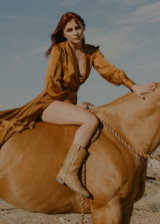 Sizzling Naked Cowgirl Riding Horse