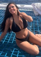 Tara Yazdi Is An Busty Brunette Displaying Her Curves In Various Bikinis