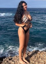 Tara Yazdi Is An Busty Brunette Displaying Her Curves In Various Bikinis