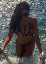 Tara Yazdi Is An Busty Brunette Displaying Her Curves In Various Bikinis
