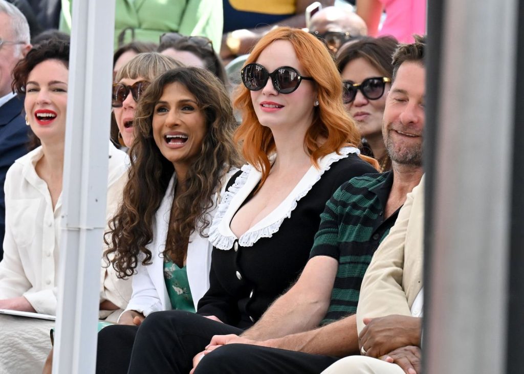 Curvy woman is at the center of an audience at a walk of fame ceremony