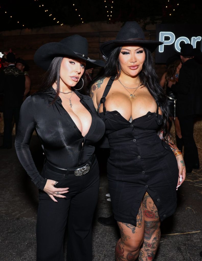 Two porn stars with huge boobs posing together at an industry event