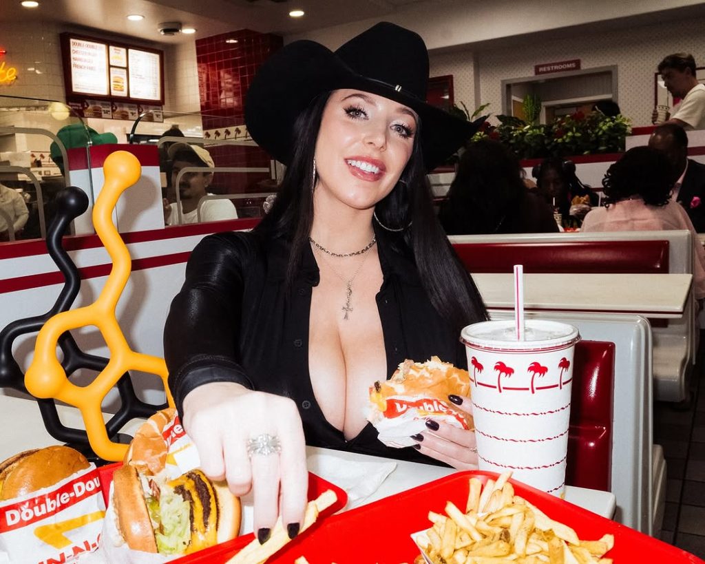 Big boob cow girl grabbing some fries at a burger place