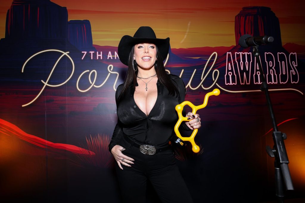 Big tit cow girl holding up her porn award
