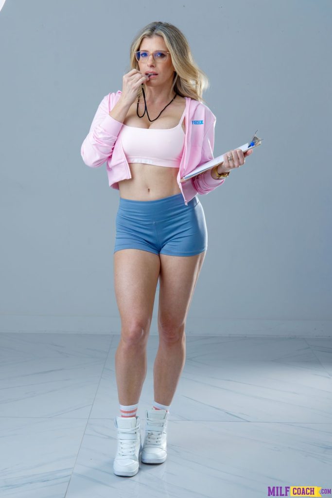 Sexy MILF coach blowing a whistle and dressed in tight shorts