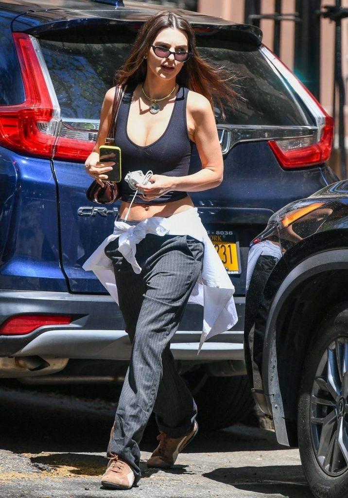 Busty brunette showing cleavage while crossing the street