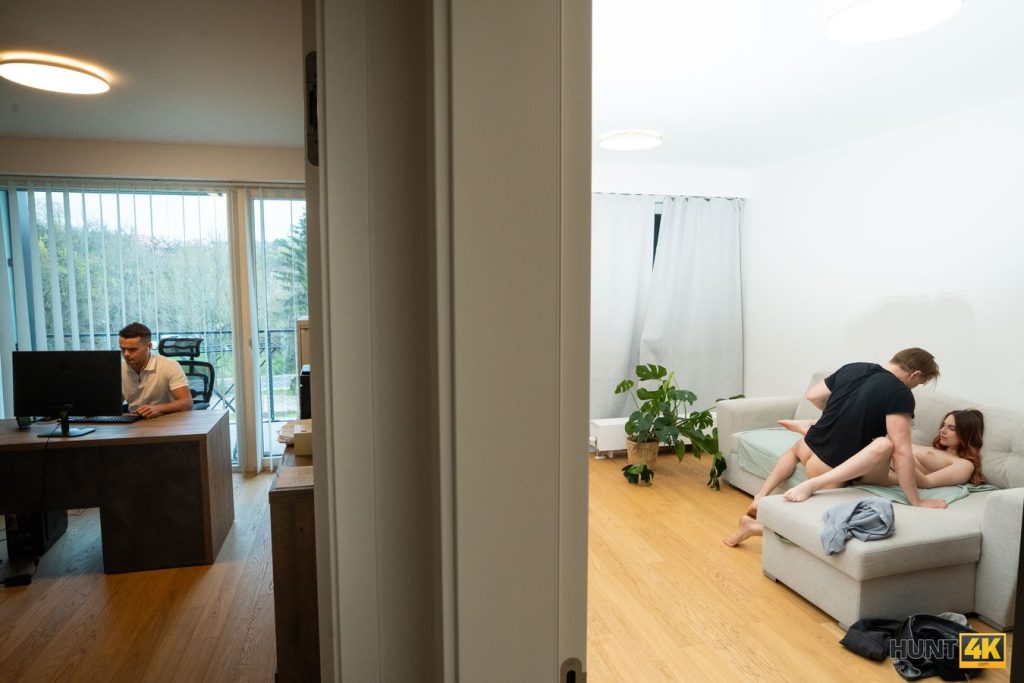 Man fucks a redhead while her boyfriends sits by the computer in another room