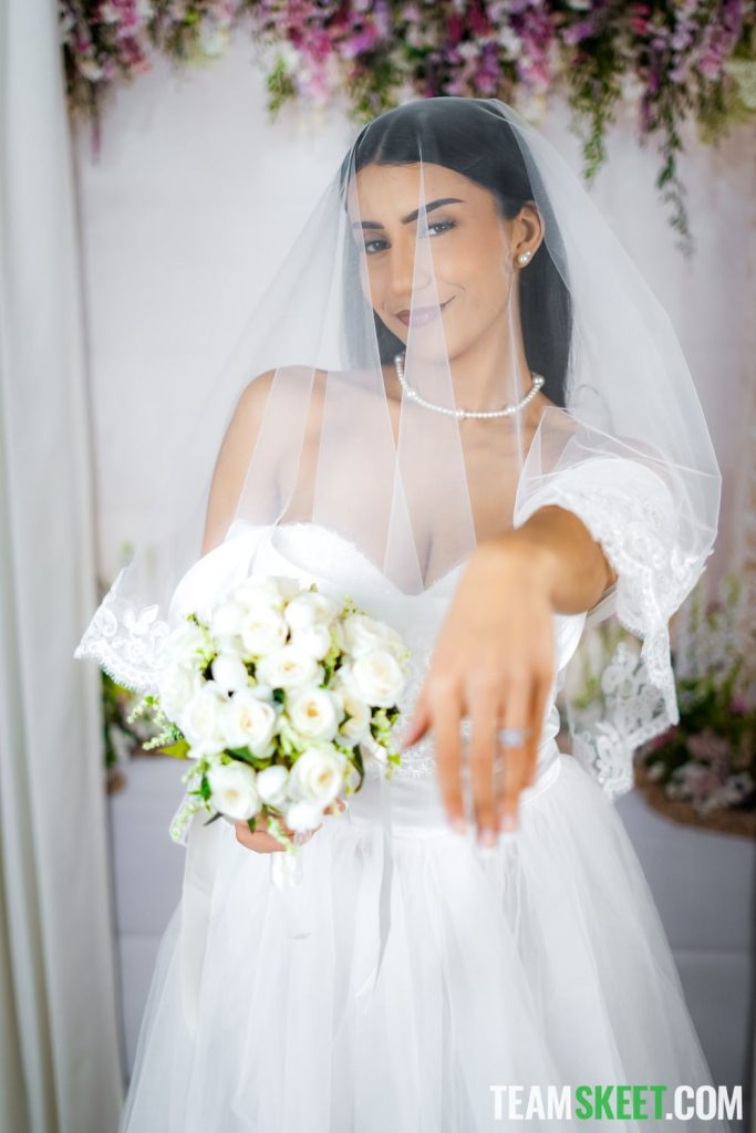 Pretty Arab bride showing off her flowers and ring