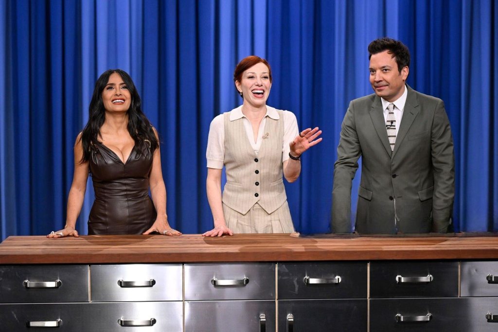Salma Hayek and Jimmy Fallon standing next to a redhead woman