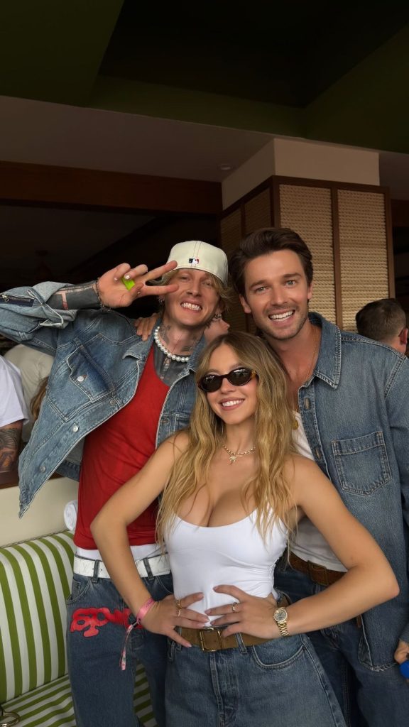 Sexy female celeb and two male celebs posing at an event