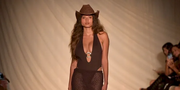 A big boob model walks the runway in a swimsuit