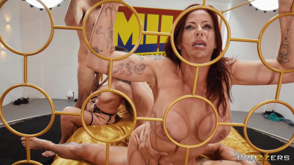 MILF grabs the bed frame while getting fucked from behind while her sexy friend sucks dick in the background