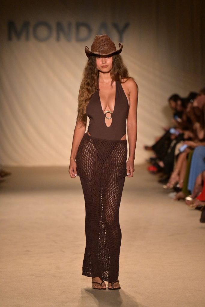 Big boob model in a swimsuit on the runway