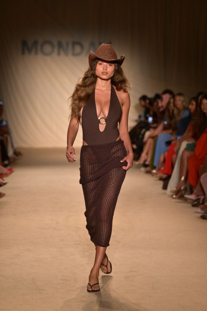 Busty model walks the runway in a swimsuit
