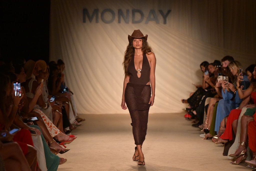 Swimsuit model walks the runway in swimsuit and cowboy hat