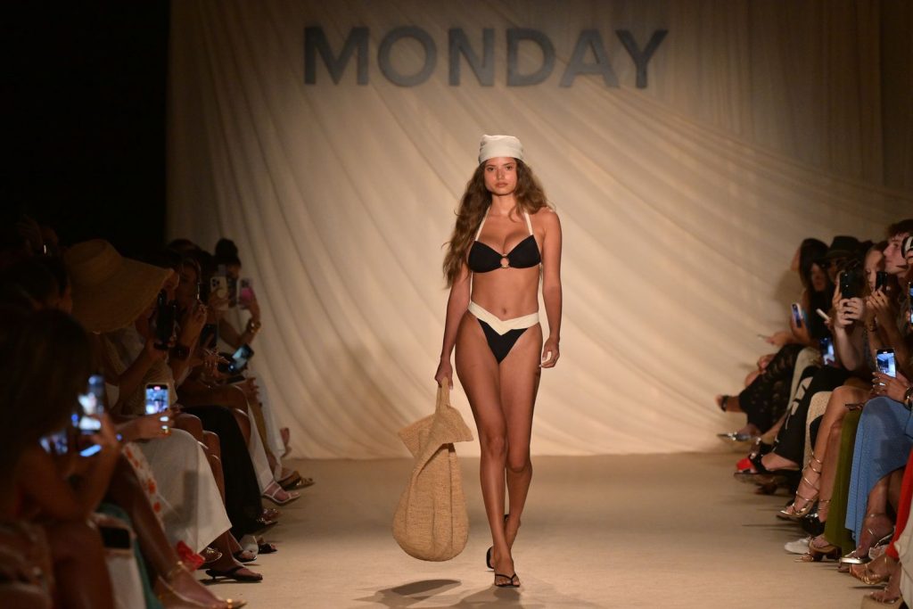 Swimsuit model walks the runway in a black and white bikini