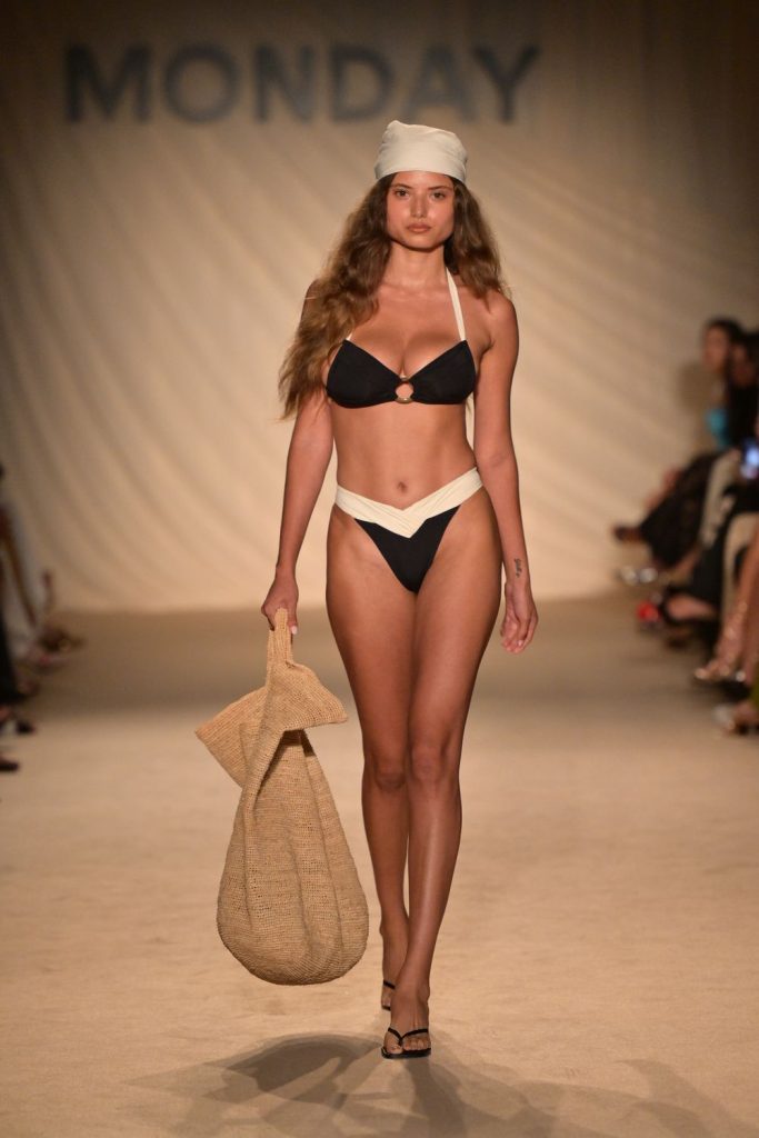 Swimsuit model busty on the fashion runway in a bikini