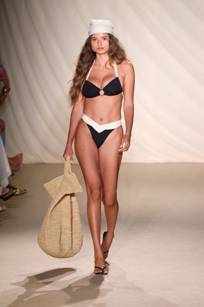 Busty Swimsuit model in a bikini on the fashion runway