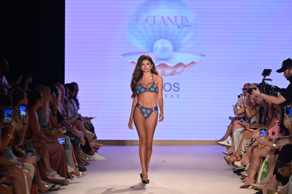 Busty bikini babe on the catwalk