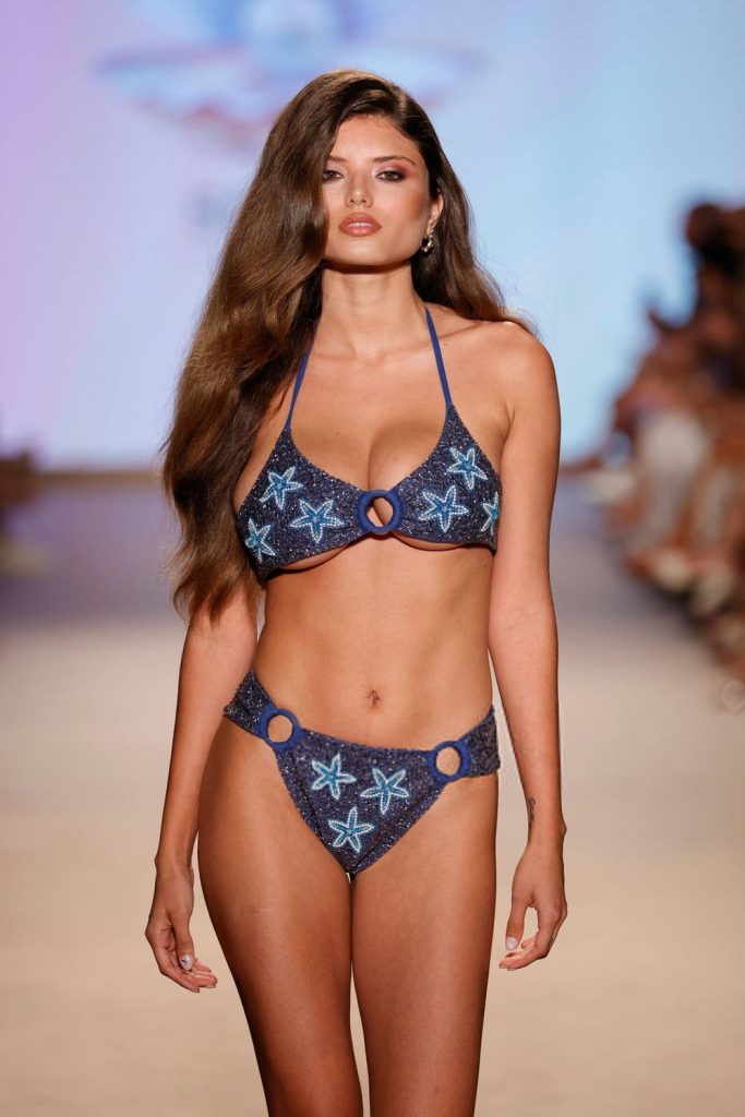 Close up of a bikini model on the runway at a fashion show