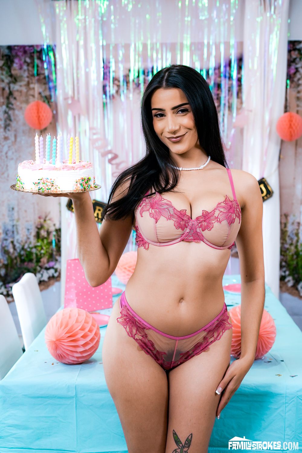 Sexy Arab babe holding up a cake and wearing underwear