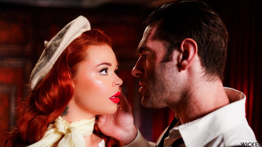 Porn star redhead and a handsome man looking like a movie stars while they stare into each other's eyes