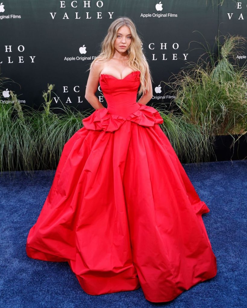 Sydney Sweeney posing in a red dress at a movie premiere