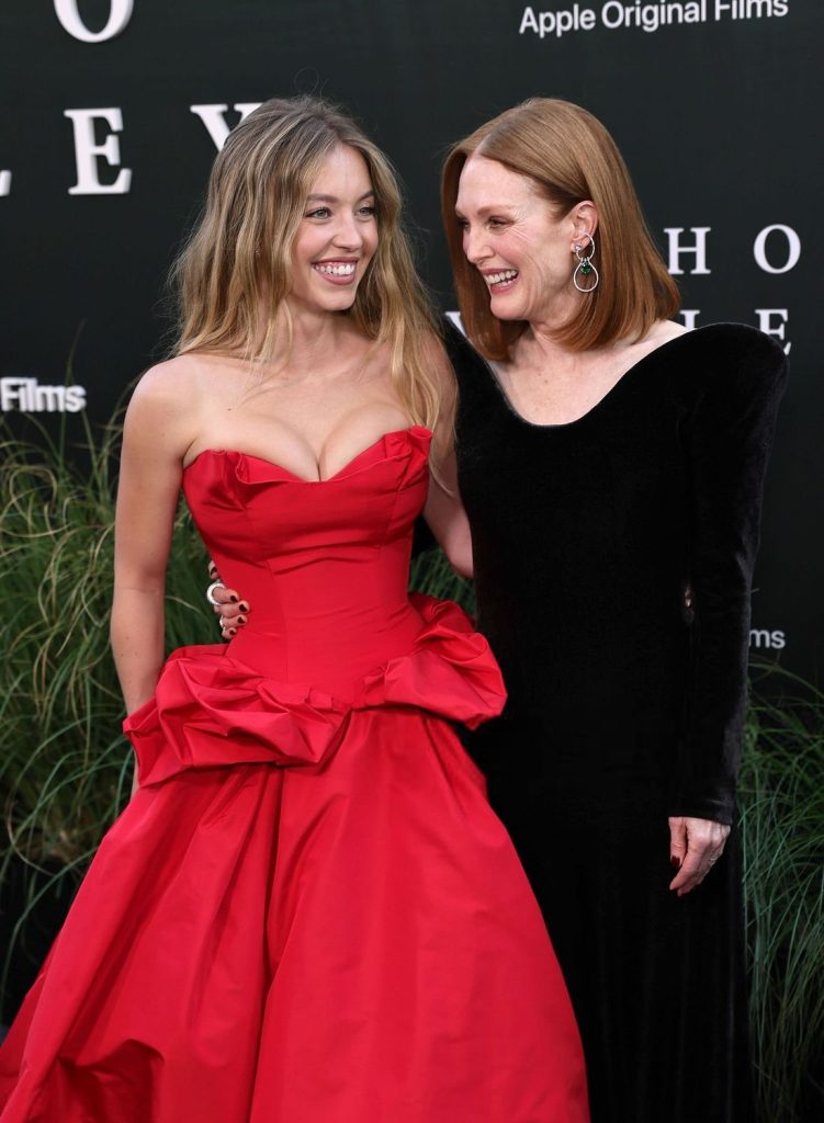 Sydney Sweeney and Julianne Moore laughs while posing together at a movie premiere