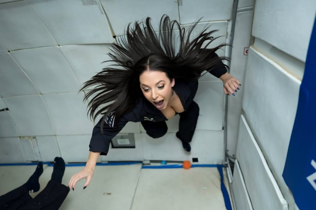 Angela White down blouse cleavage in a zero gravity plane