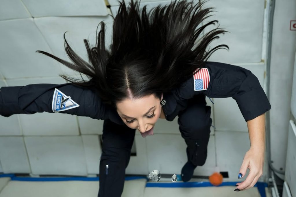 Angela White floating in zero gravity