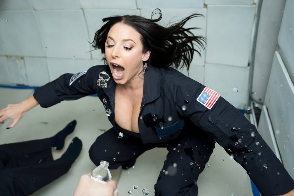 Angela White cleavage and with her mouth open while trying to catch water drops in a zero gravity plane