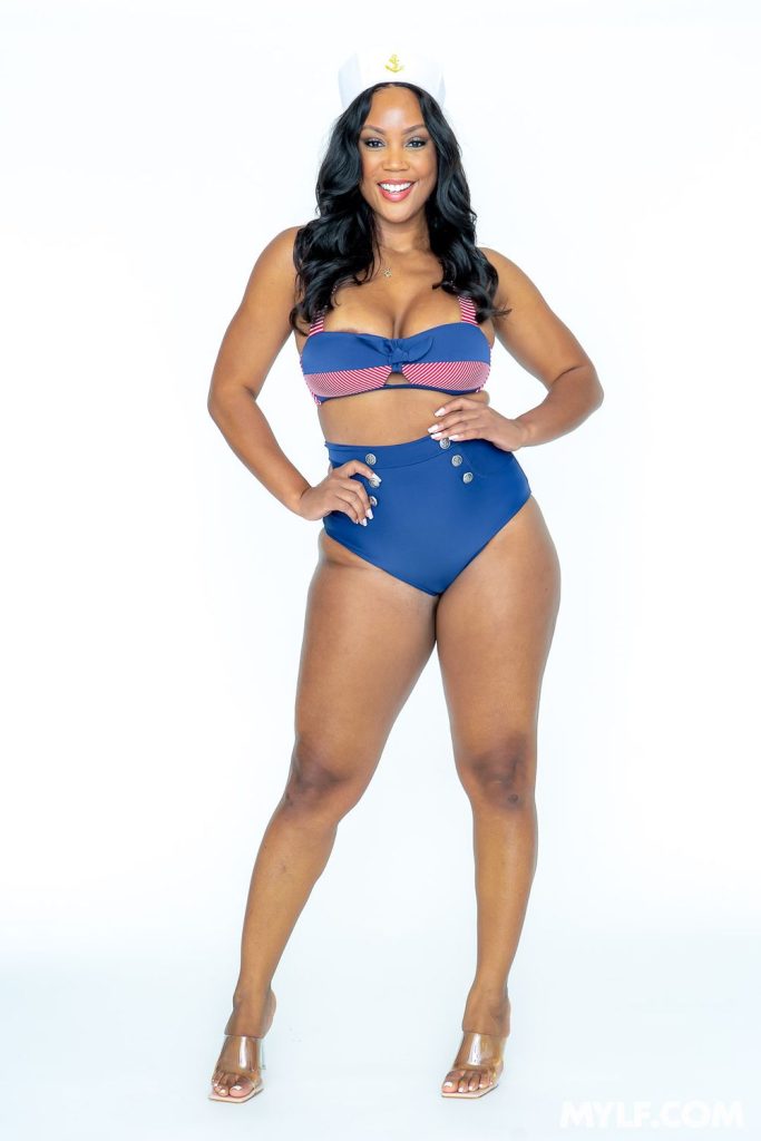 Curvy ebony babe in a sexy sailor costume strike a pose