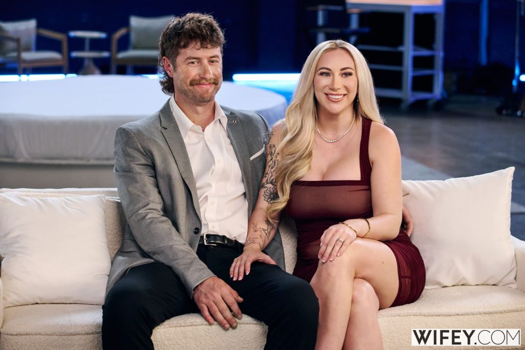 Couple sitting on a couch on the set of a porn set