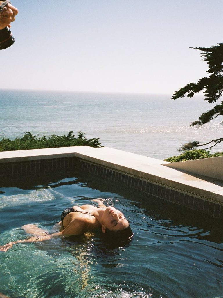 Kylie Jenner swimming on her back in a pool