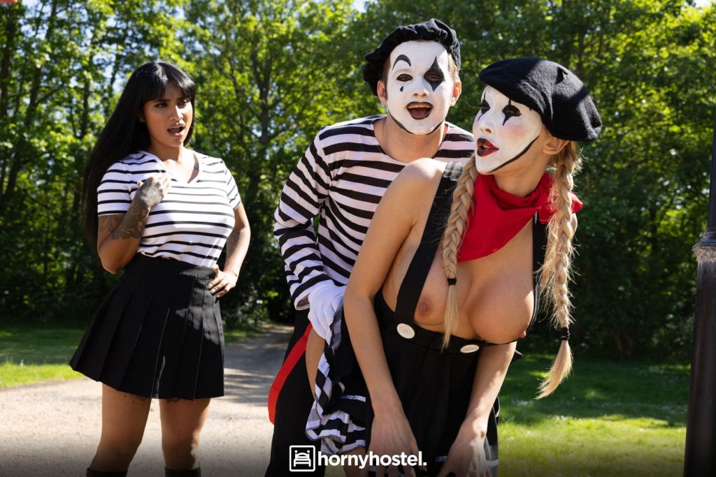 Woman shocked over a male and female mime putting on a sexual performance in the park