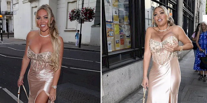 Busty blonde showing cleavage in a silk dress