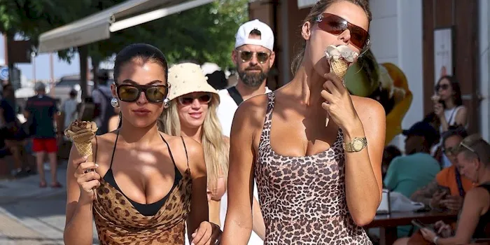 Two busy sisters showing cleavage while eating ice cream
