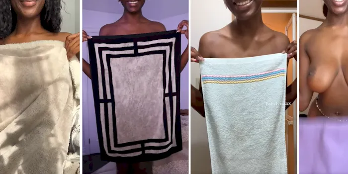 Nude ebony babe holding up towels