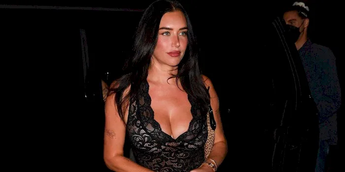 Big boob woman showing cleavage in a sexy dress at night