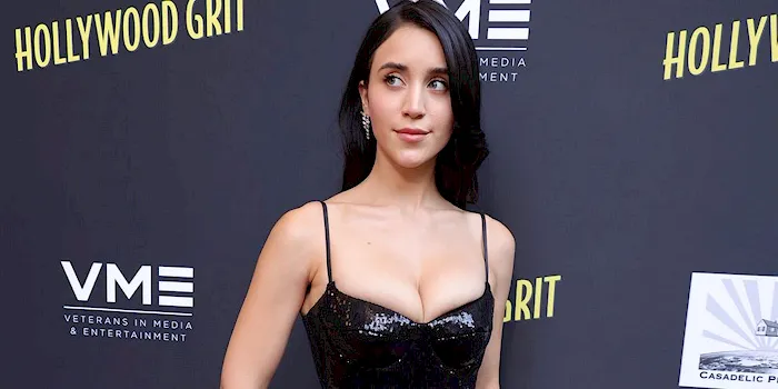 Pretty brunette Caylee Cowan showing cleavage in a black dress