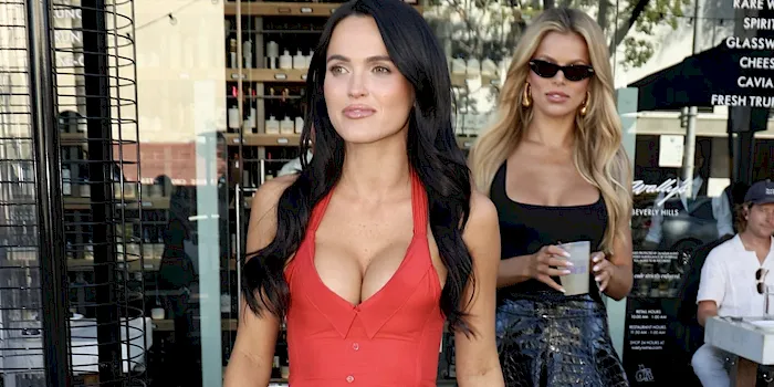 Two hot girls showing cleavage as they leave a restaurant