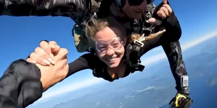 Actress Sydney Sweeney smiling while skydiving