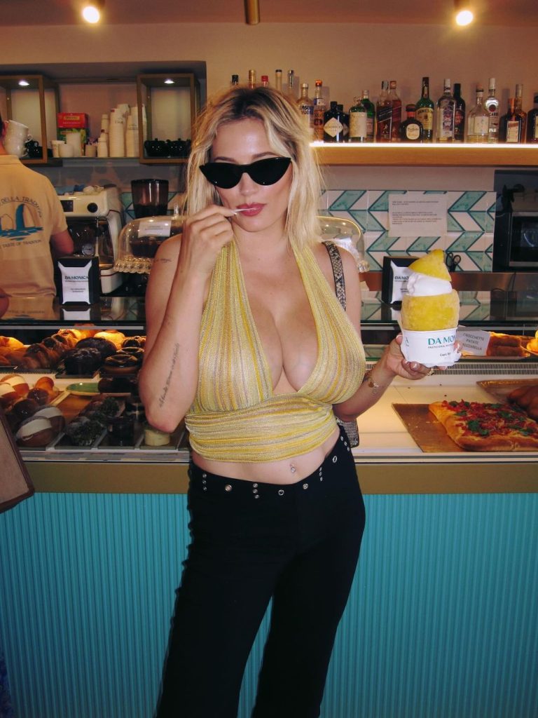 Big boob blonde showing cleavage while holding up the ice cream she just bought
