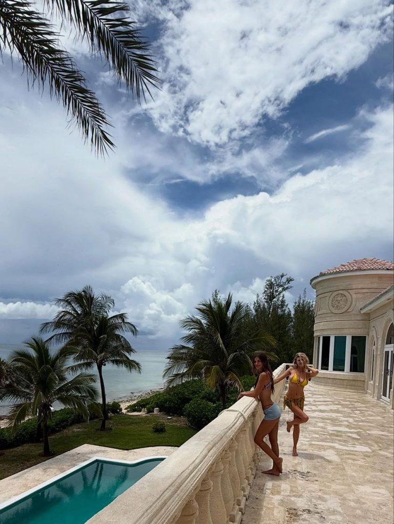 A couple of sexy women posing in bikinis on a terrace at a Caribbean island